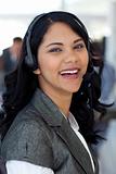 Smiling businesswoman with a headset on in company