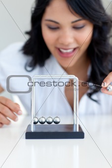 Businesswoman playing with Newton balls