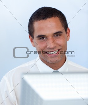 Smiling businessman working with a computer