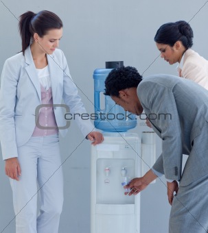 Business colleagues talking around a water cooler