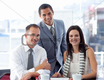 Business people working together and smiling at the camera