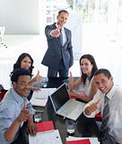 Business people in a meeting with thumbs up