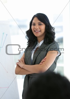 Smiling businesswoman with folded arms in a presentation