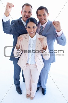 Happy business team celebrating a success with arms up