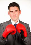 Serious businessman with boxing gloves