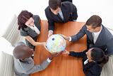 High Angle of business people holding a globe. Global business