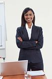 Confident ethnic businesswoman in office