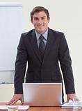 Confident attractive businessman in office