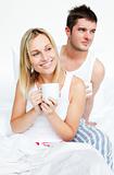 Couple drinking a cup of tea in bed