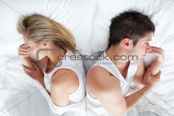 Couple lying in bed after having a fight. Marriage trouble