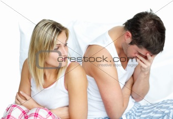 Woman and man having an argument in bed