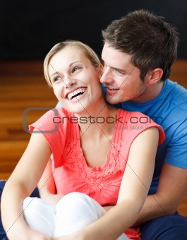 Couple sitting on the floor of their new apartment