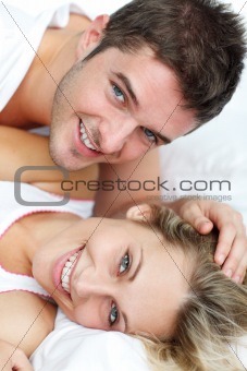 Lovers together sitting on bed