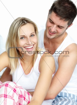 Lovers together sitting on bed