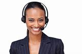 Beautiful ethnic businesswoman with a headset on smiling at the 