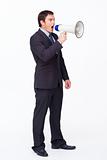 Standing businessman shouting through a megaphone