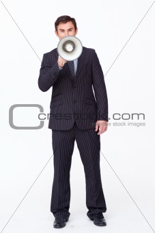 Attractive businessman shouting through a megaphone