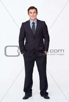 Smiling businessman with his hands in his pockets