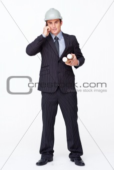 Attractive architect on phone holding plans