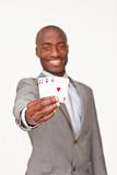Attractive Afro-American businessman holding four aces
