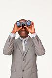 Afro-American businessman looking through binoculars