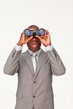 Surprised Afro-American businessman looking through binoculars