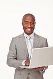 Afro-American businessman using a laptop and smiling