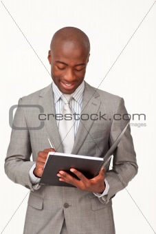Attractive businessman writing notes
