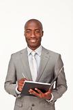 Attractive smiling Afro-American businessman writing notes