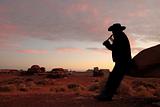 Male Playing Flute in the Desert