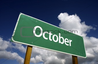 October Green Road Sign with dramatic blue sky and clouds - Months of the Year Series.