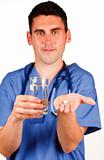 Doctor holding a pill and a glass of water