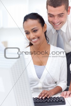 Businessman and businesswoman using a laptop