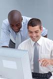 Caucasian and Afro-American businessmen using a laptop