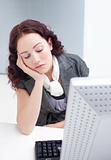 Young businesswoman sleeping in front of a computer
