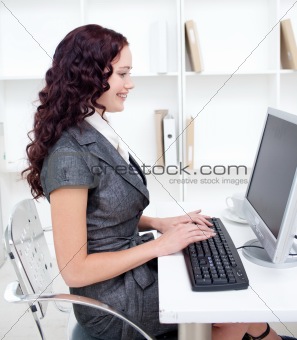 Young businesswoman working in office with a computer