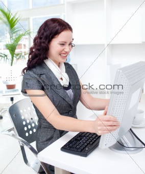 Young businesswoman getting frustrated with a computer