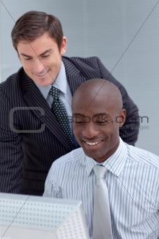 Businessmen using a laptop together
