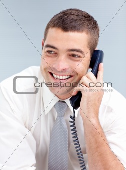 Smiling businessman in office talking on phone