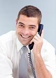 Attractive businessman on phone in office