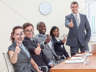 Businessteam with thumbs up after a presentation