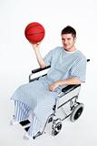 Patient in wheelchair holding a basket ball