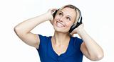 Happy woman listening to music with headphones on