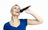 Woman singing on a microphone against white background