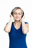 Happy woman listening to music with closed eyes