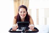 Smiling woman doing spinning at home