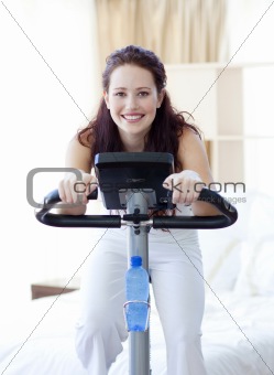 Woman doing spinning bike at home