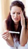 Woman looking at a pregnancy test
