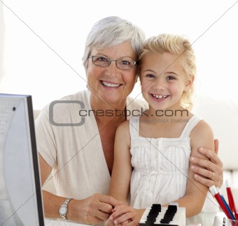 Portrait of granddaughter and grandmother using a computer