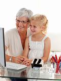 Granddaughter and grandmother using a computer